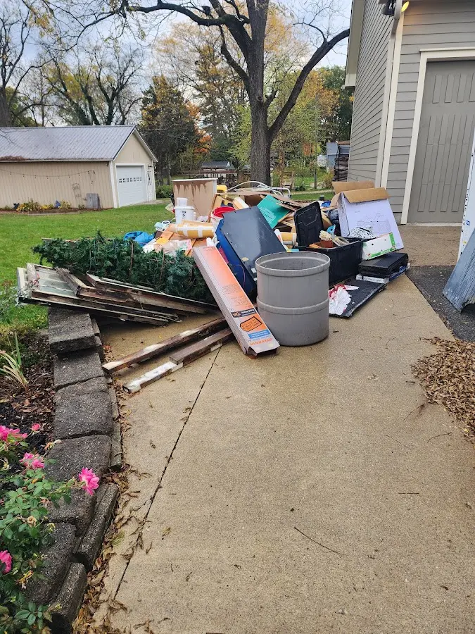 Dumpster being loaded with debris for 10 Yard Dumpster Rental in Celina